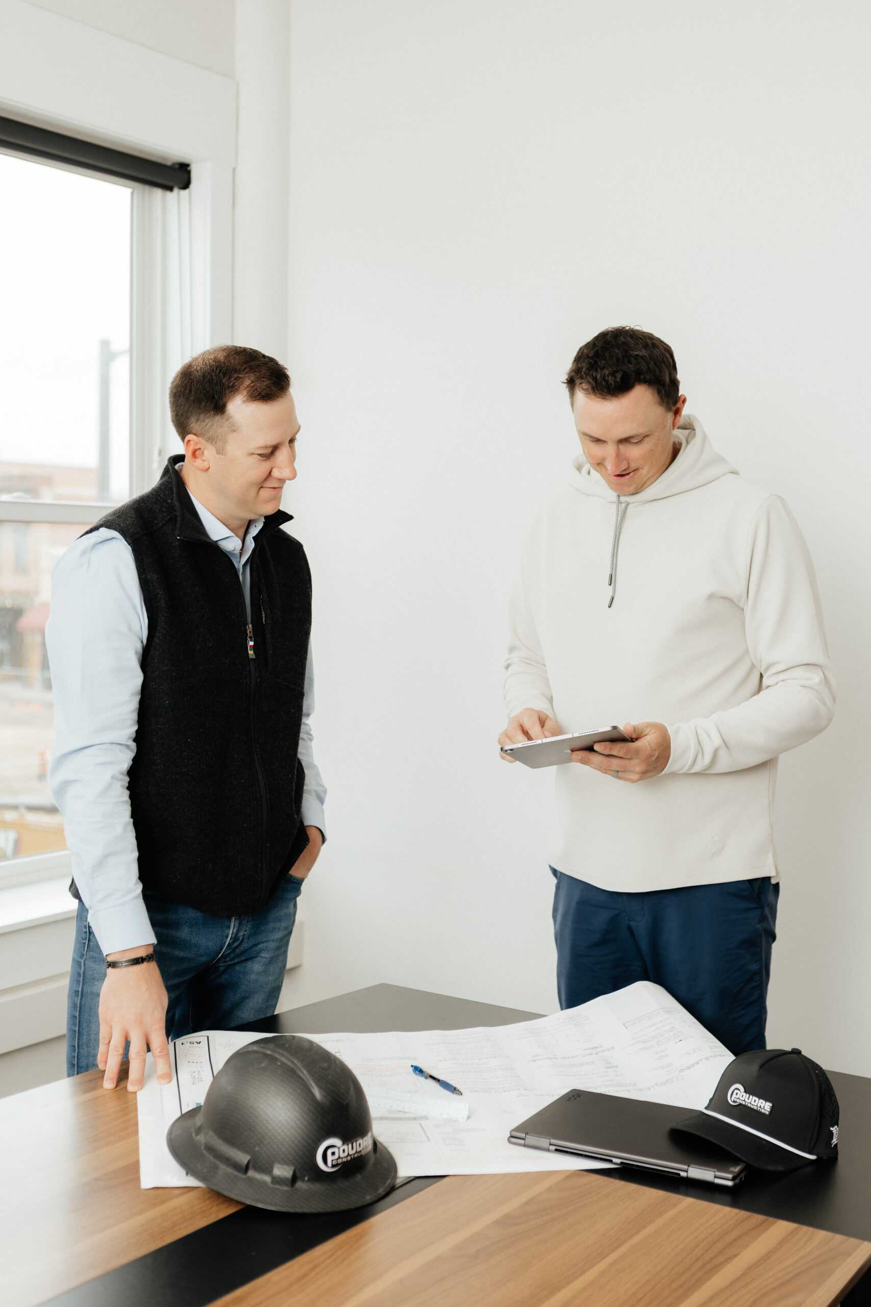 Cory Jennings and Beau Brittenham talking in an office.